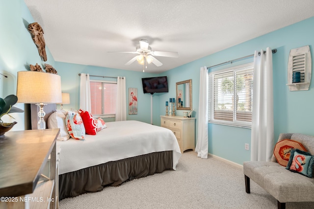 bedroom featuring baseboards, a ceiling fan, a textured ceiling, and light carpet