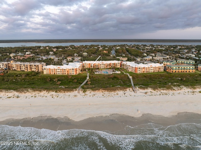 drone / aerial view with a beach view and a water view
