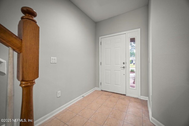 foyer entrance with baseboards and light tile patterned floors