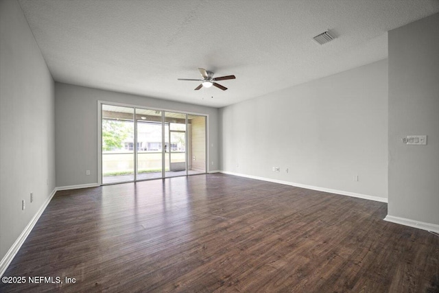 empty room featuring baseboards, a ceiling fan, and dark wood-style flooring