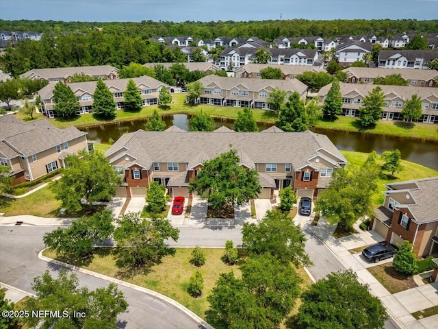birds eye view of property featuring a water view and a residential view
