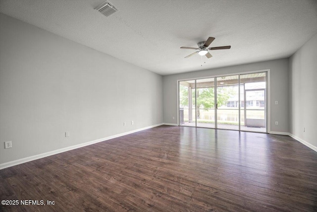 empty room with a ceiling fan, a textured ceiling, visible vents, and dark wood-type flooring