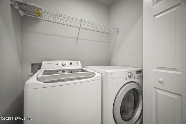 washroom featuring washing machine and dryer