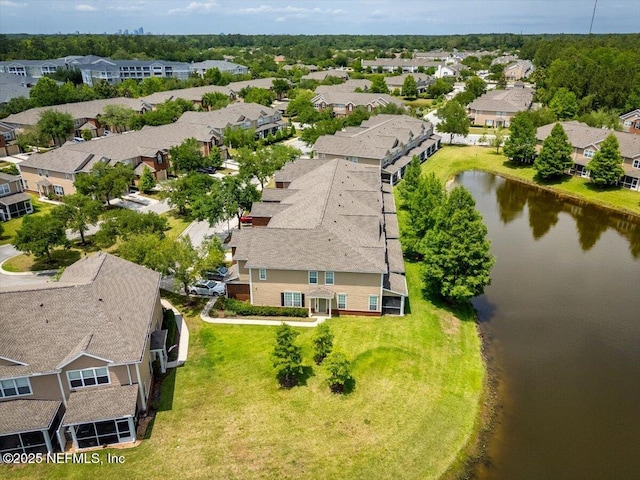 drone / aerial view with a residential view and a water view