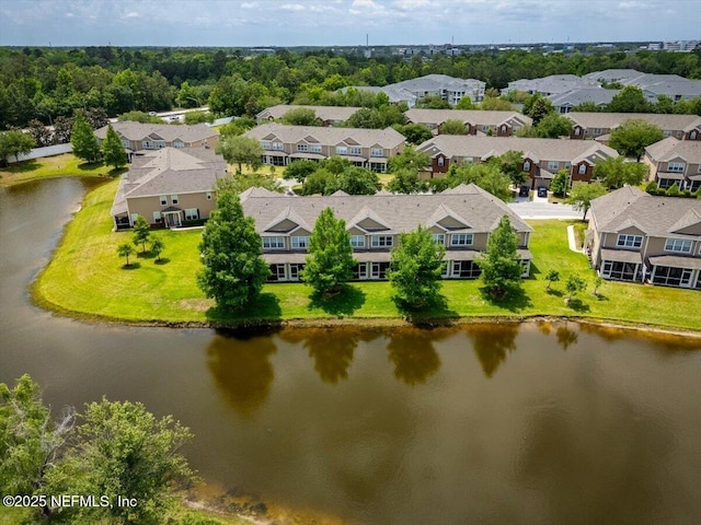 drone / aerial view with a water view and a residential view