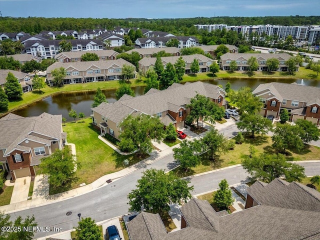 drone / aerial view with a water view and a residential view