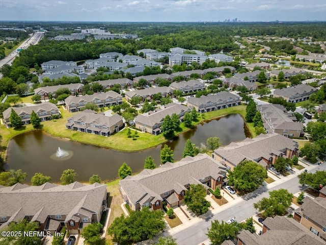 drone / aerial view with a residential view and a water view