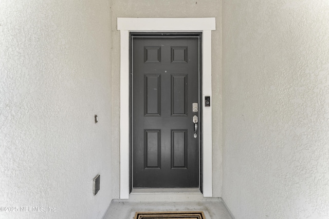 entrance to property with stucco siding