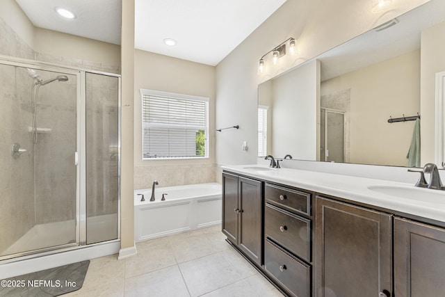bathroom with double vanity, a sink, a bath, and a shower stall