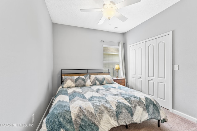 carpeted bedroom featuring a closet, baseboards, and ceiling fan