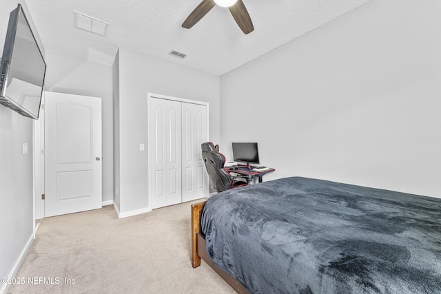 bedroom with visible vents, a textured ceiling, carpet, and baseboards