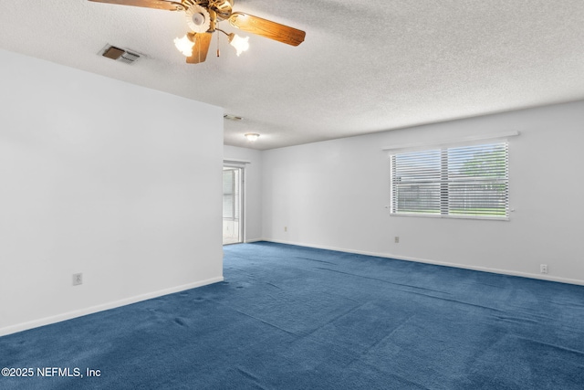 carpeted empty room with a ceiling fan, a textured ceiling, visible vents, and a healthy amount of sunlight