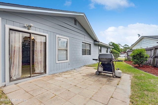view of patio featuring fence and area for grilling