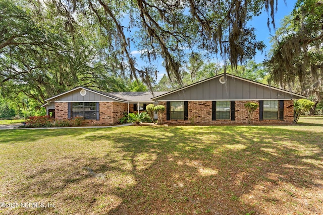127 Old Jennings Rd, Orange Park, FL 32065 - ranch-style house with brick siding, board and batten siding, and a front yard