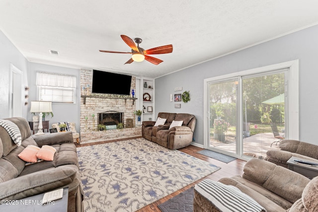 127 Old Jennings Rd, Orange Park, FL 32065 - living room featuring a healthy amount of sunlight, a ceiling fan, wood finished floors, and visible vents