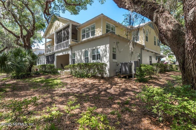 exterior space featuring central AC unit and stucco siding