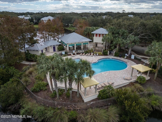 community pool featuring a gazebo, a patio area, and fence