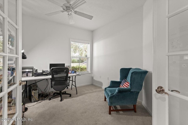 home office with carpet floors, baseboards, a ceiling fan, and a textured ceiling