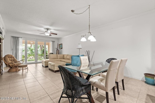 dining room with crown molding, a textured ceiling, light tile patterned floors, and ceiling fan with notable chandelier