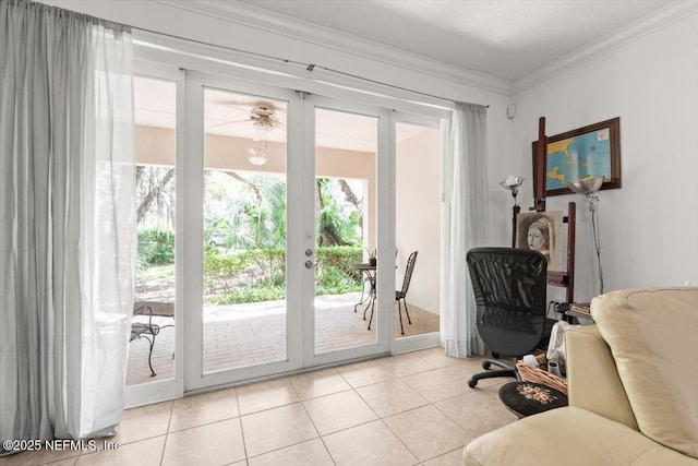 doorway with french doors, ornamental molding, ceiling fan, and light tile patterned floors