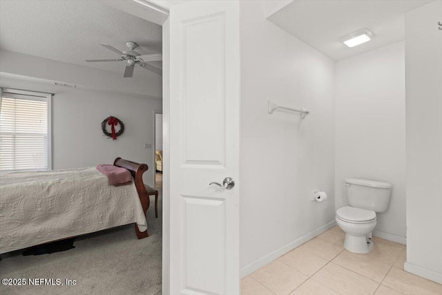 bathroom with a ceiling fan, tile patterned flooring, baseboards, toilet, and ensuite bath