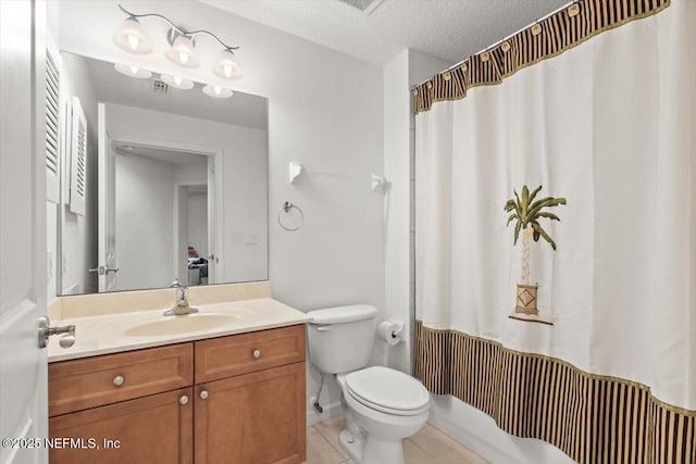 full bathroom with vanity, tile patterned floors, toilet, and a textured ceiling