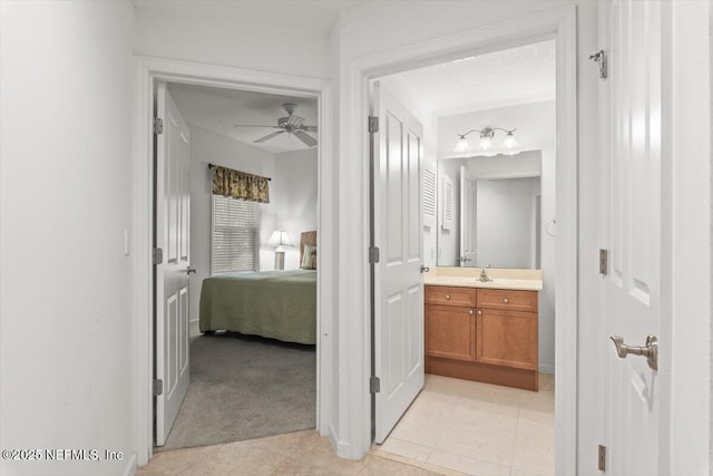 bathroom featuring connected bathroom, a ceiling fan, and vanity