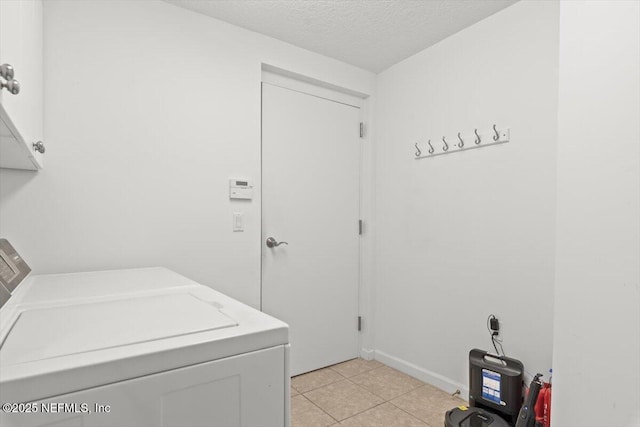 laundry room featuring light tile patterned floors, separate washer and dryer, laundry area, and a textured ceiling