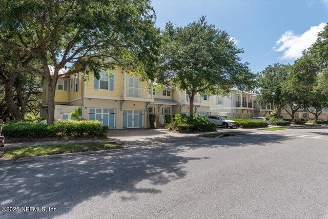 townhome / multi-family property with an attached garage, driveway, and a residential view