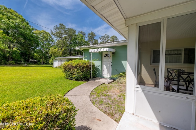 doorway to property with a yard