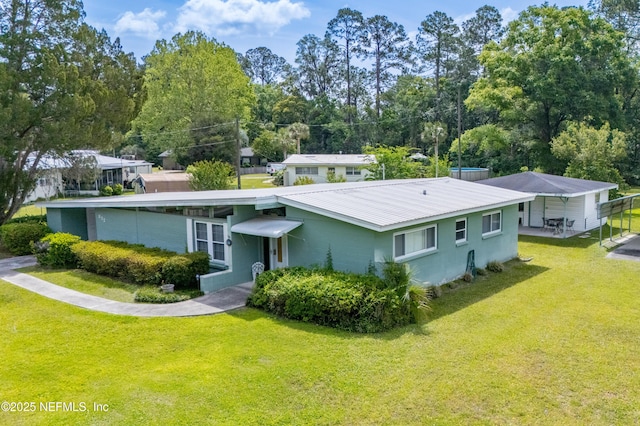 back of property with a lawn and metal roof