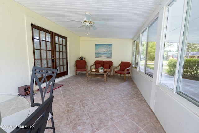 sunroom featuring ceiling fan, outdoor lounge area, and french doors