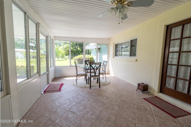 sunroom / solarium featuring a ceiling fan