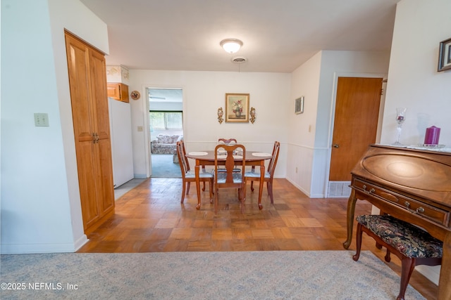 dining space with baseboards and visible vents