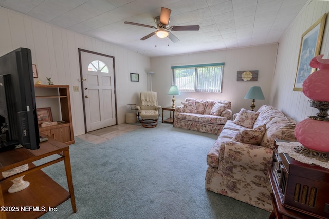 living area featuring carpet and a ceiling fan