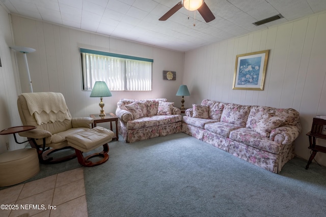 living room with visible vents, a ceiling fan, and carpet floors