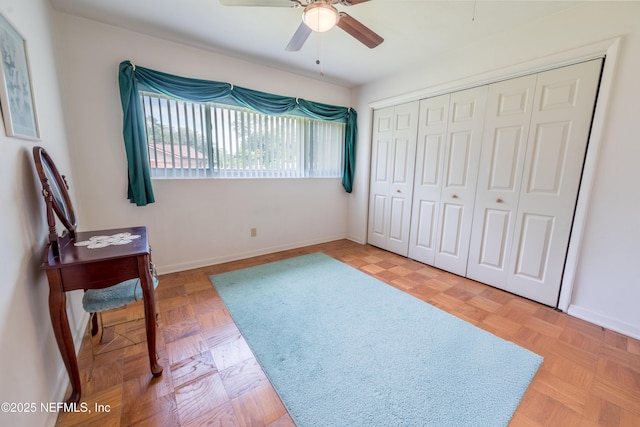 bedroom featuring baseboards, a ceiling fan, and a closet
