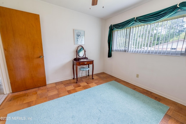 unfurnished room featuring baseboards and a ceiling fan