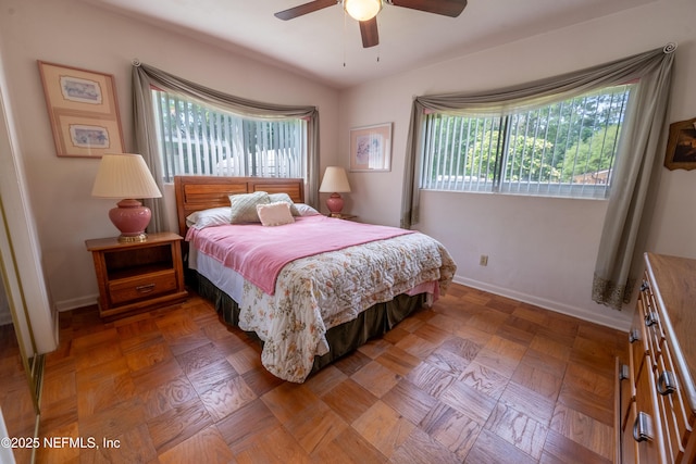 bedroom featuring baseboards and ceiling fan