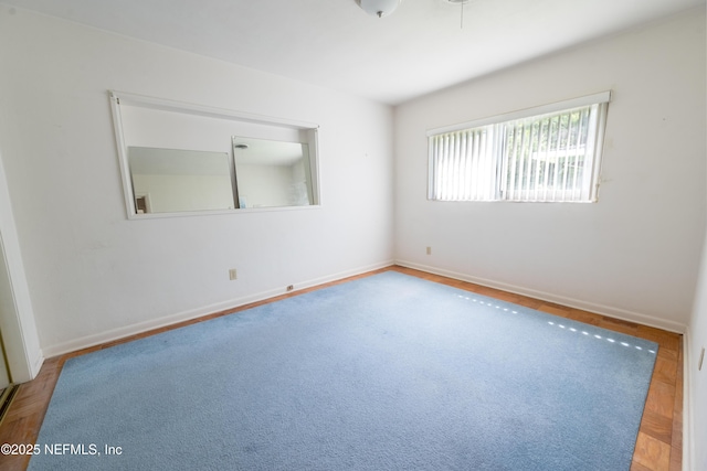 spare room with baseboards