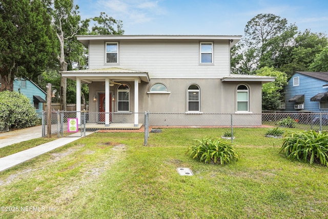 view of front of home featuring fence and a front yard
