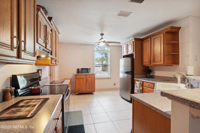 kitchen featuring a sink, stainless steel appliances, brown cabinets, and under cabinet range hood