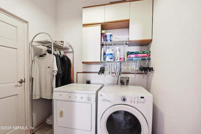 clothes washing area featuring washing machine and clothes dryer and tile patterned floors