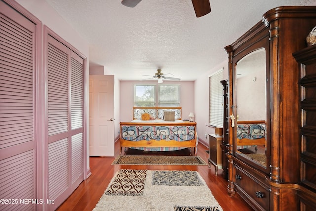 hall featuring a textured ceiling and dark wood finished floors