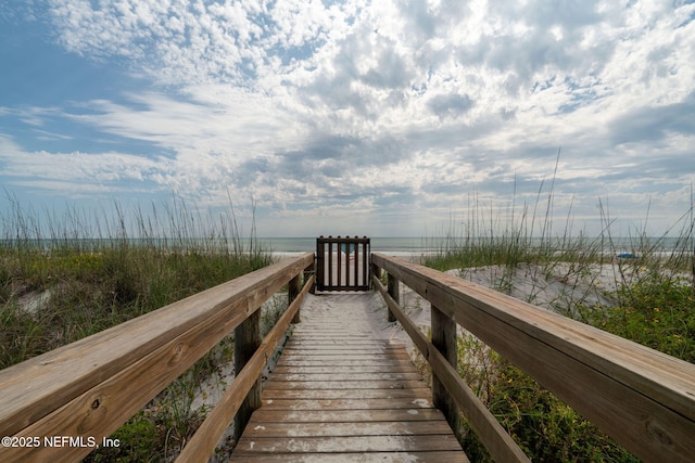 surrounding community with view of water and beach