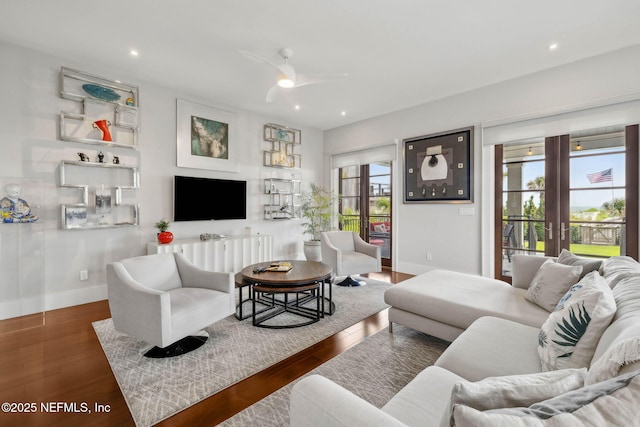 living area featuring baseboards, recessed lighting, ceiling fan, and wood finished floors