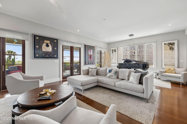 living room with recessed lighting, baseboards, and wood finished floors
