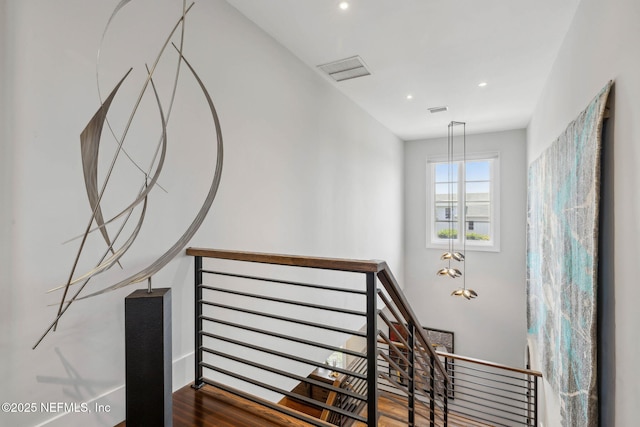 stairs featuring visible vents, recessed lighting, baseboards, and wood finished floors