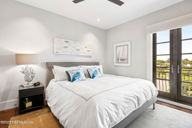 bedroom featuring access to outside, multiple windows, french doors, and wood finished floors