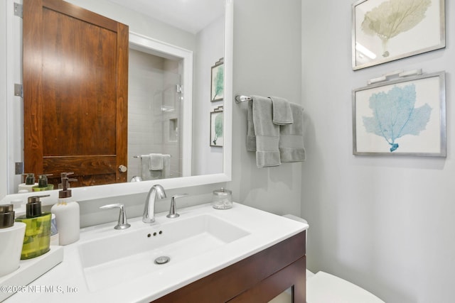 full bath with vanity, walk in shower, and toilet